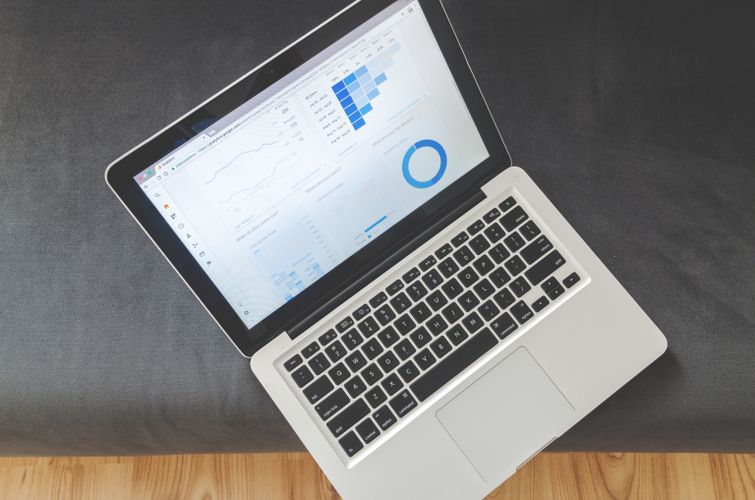 Laptop screen with data visualizations and analytics charts