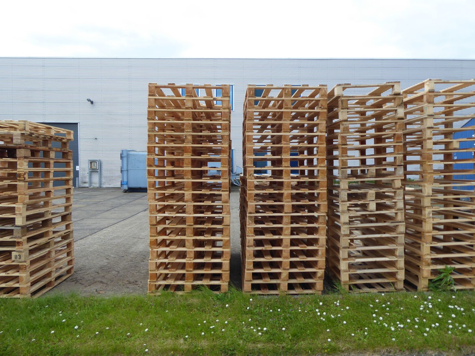 Stacked wooden pallets outside a distribution centre