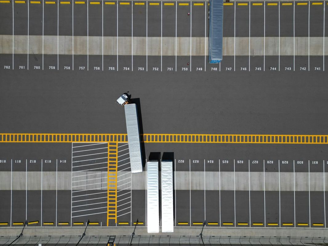 Aerial view of a distribution yard and its marked trailer bays